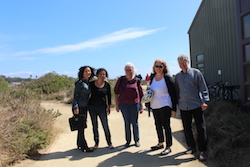 conference attendees pose for a photo outside a building